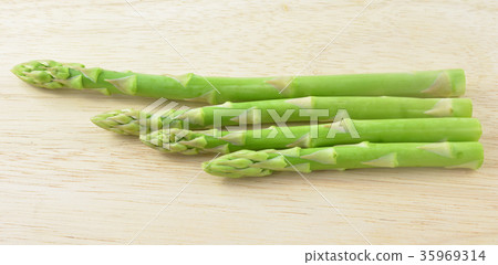 ripe green asparagus on a wooden background 35969314