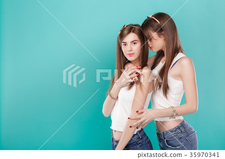 sisters twins on blue background.  35970341