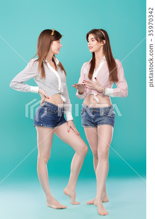 sisters twins on blue background.  35970342