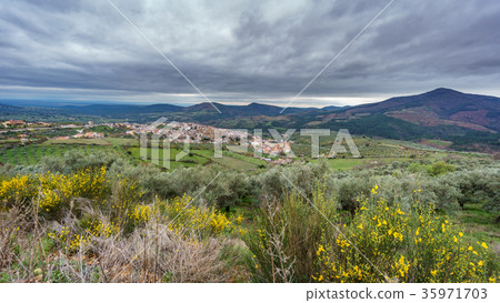 Guadalupe abbey and village with cloudy sky Guadalupe abbey and village with cloudy sky 35971703