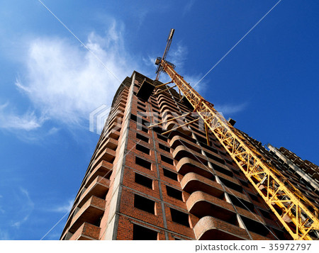 Construction crane near building on blue sky 35972797