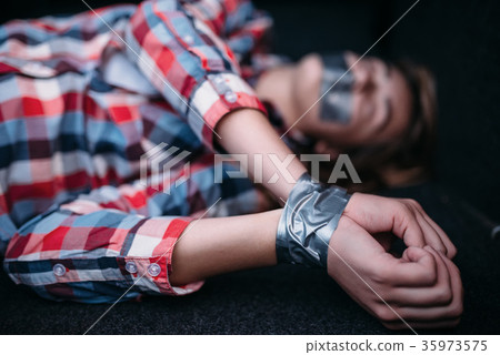 Victim of maniac, mouth and hands sealed with tape Victim of maniac, mouth and hands sealed with tape 35973575
