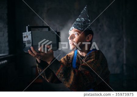 Paranoid man in tinfoil cap, mind protection, UFO 35973975