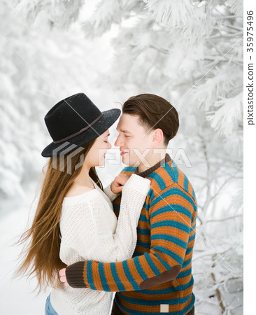Happy young couple in winter forest. Winter love 35975496