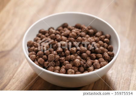 chocolate cereal balls in white bowl for breakfast chocolate cereal balls in white bowl for breakfast 35975554