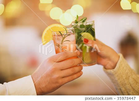 Two cocktail glasses in man and woman hand 35978447