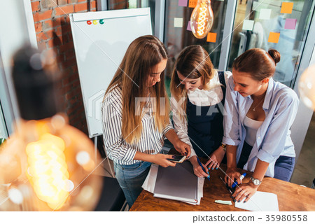 Top view of three cheerful female students looking Top view of three cheerful female students looking 35980558