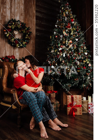 couple in red T-shirts and pajamas is sitting in couple in red T-shirts and pajamas is sitting in 35982220