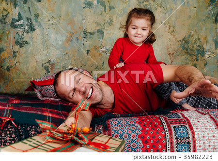 Father and daughter are fighting for a gift on the Father and daughter are fighting for a gift on the 35982223