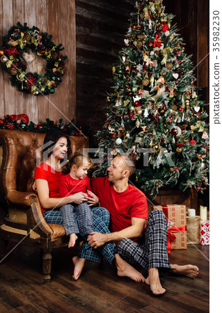 couple in red T-shirts and pajamas is sitting in couple in red T-shirts and pajamas is sitting in 35982230