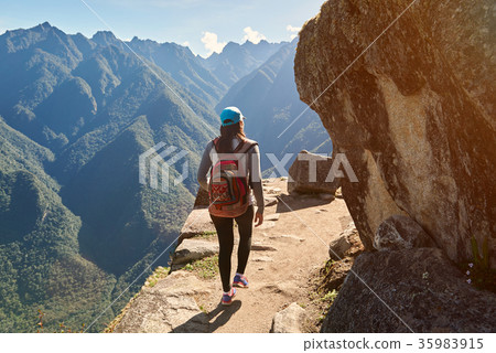 Woman walk on narrow mountain path Woman walk on narrow mountain path 35983915