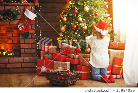 happy child girl decorated Christmas tree 35984059