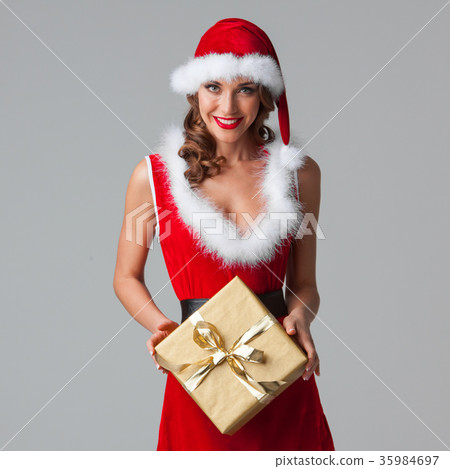 Woman in santa hat with gift 35984697