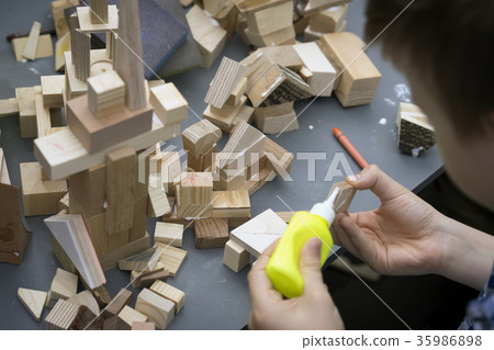 Close-up of child's hands playing with wooden Close-up of child's hands playing with wooden 35986898