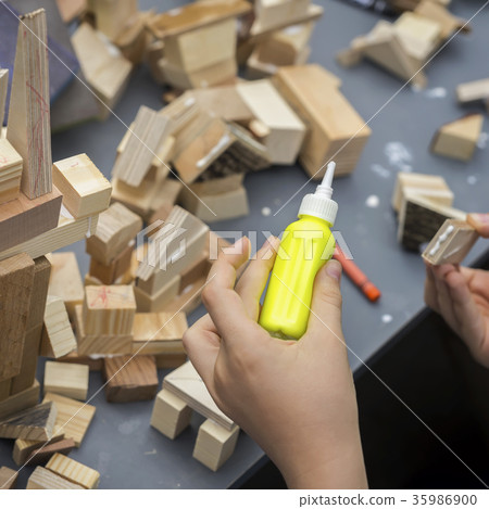 Close-up of child's hands playing with wooden 35986900