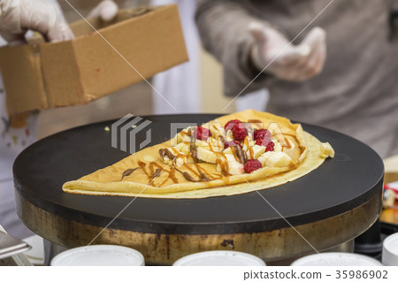 Close-up of hands of cook in gloves preparing 35986902