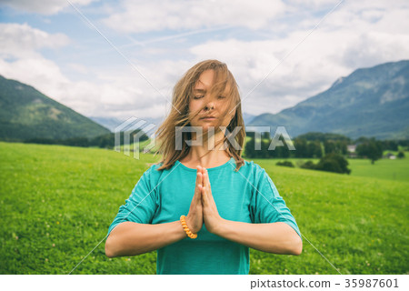 Portrait of Young woman on the green field Portrait of Young woman on the green field 35987601