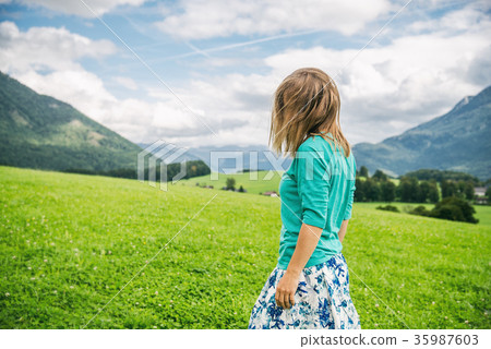 Portrait of Young woman on the green field Portrait of Young woman on the green field 35987603
