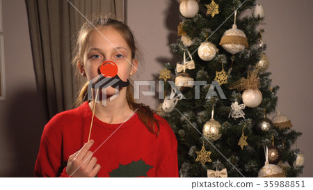 Girl holding banner with red nose and moustache 35988851