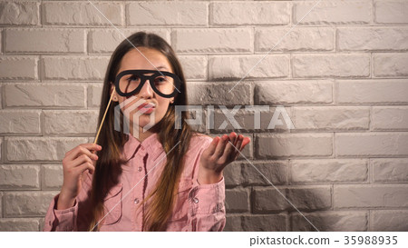 Girl holding a banner with black glasses 35988935