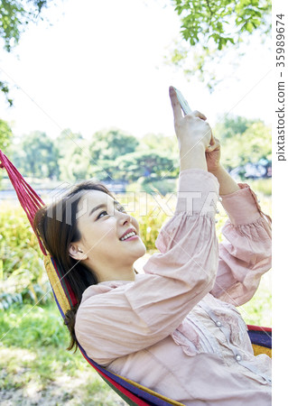 Young woman, park, smart phone Young woman, park, smart phone 35989674