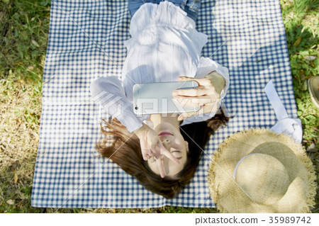 Young woman, park, smart phone 35989742