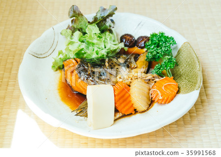 Boiled Head of salmon fish with sweet sauce and vegetable Boiled Head of salmon fish with sweet sauce and vegetable 35991568