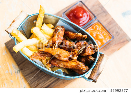 Fried chicken wing with french fries 35992877