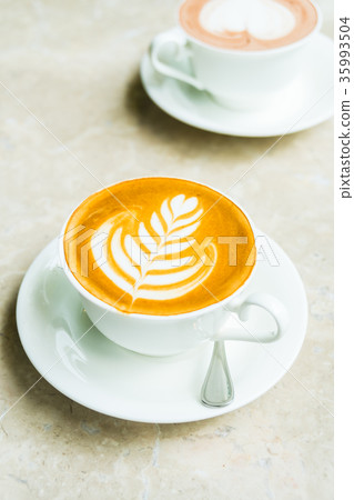 White cup with latte coffee and cake White cup with latte coffee and cake 35993504