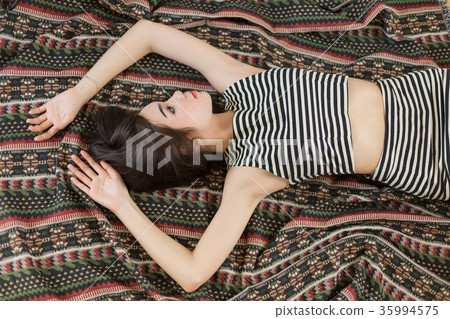 Asian girl is lie down on the rug. Asian girl is lie down on the rug. 35994575