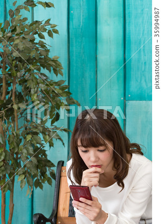 Woman looking at smartphone during date 35994987