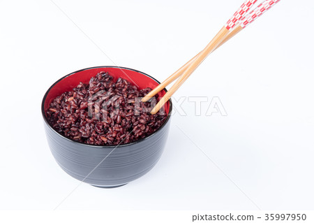 brown rice in the black bowl and chopped brown rice in the black bowl and chopped 35997950