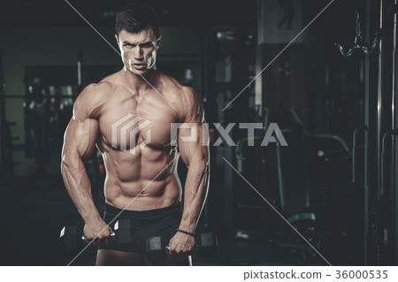 Handsome model young man posing in gym 36000535