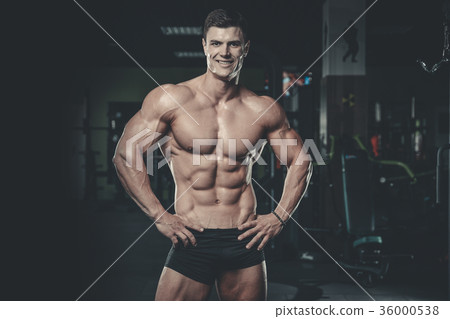 Attractive model young man training in gym 36000538