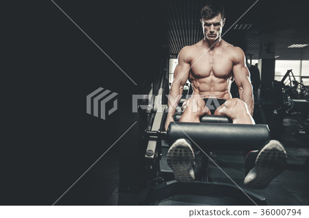 Handsome model young man training legs in gym Handsome model young man training legs in gym 36000794