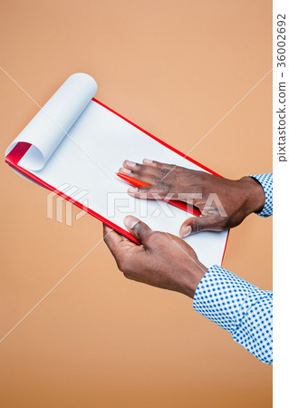 Male hand holding pen, isolated Male hand holding pen, isolated 36002692