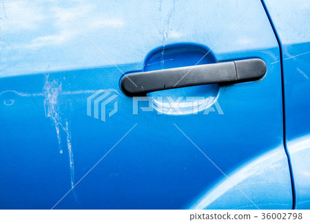 Blue car door handle and scratched car paint with 36002798