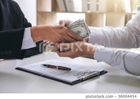 Bribery and corruption concept, bribe in the form of dollar bill Bribery and corruption concept, bribe in the form of dollar bill 36004454