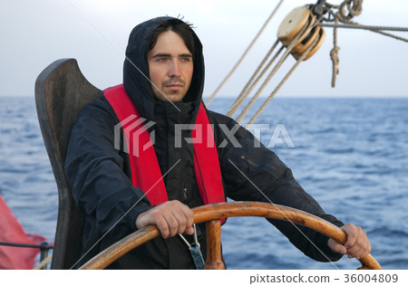 Young sailor steering tall ship 36004809