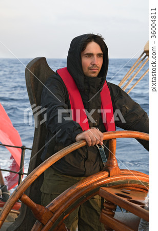 Young sailor steering tall ship 36004811