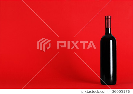 bottle of wine on a red background bottle of wine on a red background 36005176