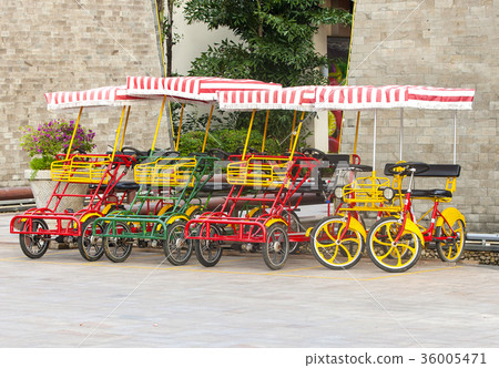Bicycle with four wheels on the square. Bicycle with four wheels on the square. 36005471