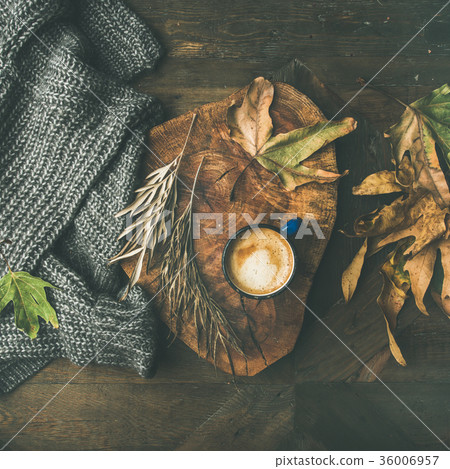 Autumn coffee concept with leaves and grey sweater Autumn coffee concept with leaves and grey sweater 36006957