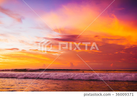 Ocean with waves at colorful bright sunset Ocean with waves at colorful bright sunset 36009371