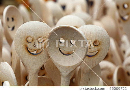 Wooden cooking spoons with smiling face carved 36009721