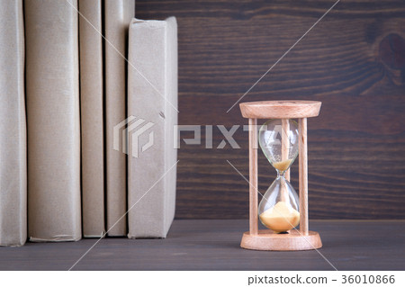 Sandglass, hourglass or egg timer on wooden table showing the last second or last minute or time out 36010866