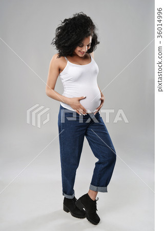 Pregnant woman standing in full length Pregnant woman standing in full length 36014996