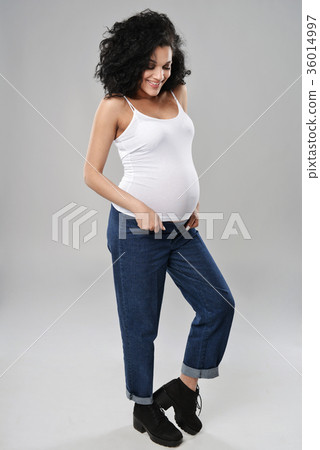 Pregnant woman standing in full length Pregnant woman standing in full length 36014997