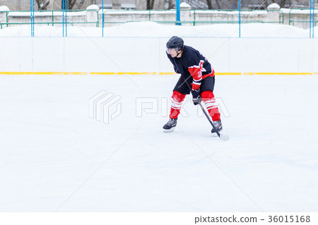 Ice hockey skater with stick on rink Ice hockey skater with stick on rink 36015168