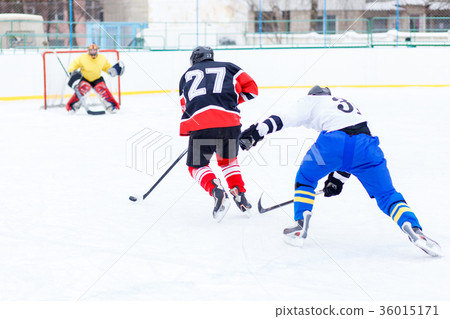 Young skater man in attack. Ice hockey game 36015171